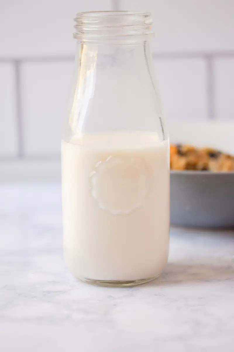 a glass bottle filled with almond milk
