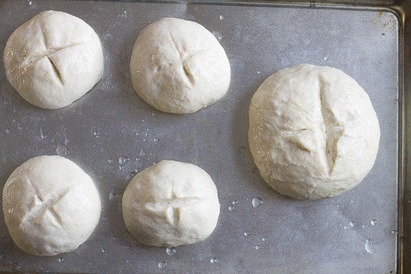 unbaked bread bowls on a sheet pan,
