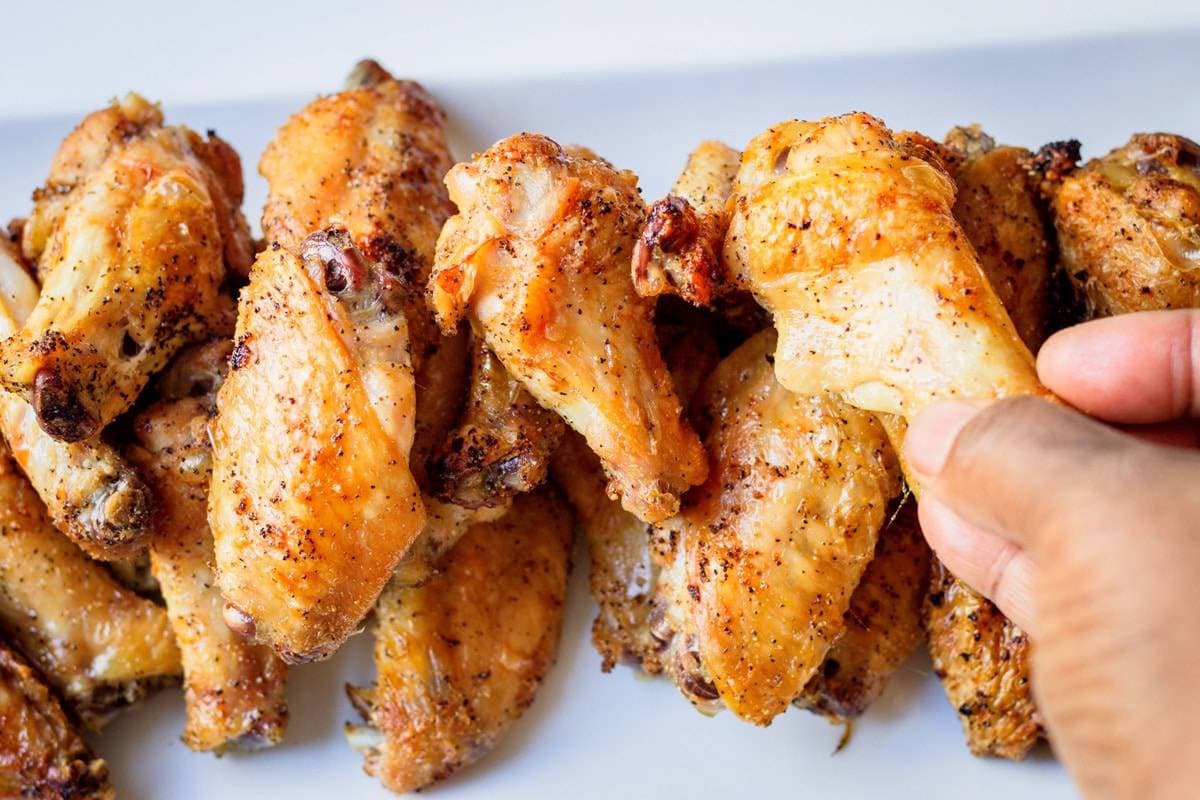 holding a crispy chicken drum