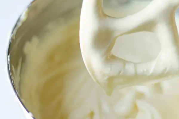 smooth cheesecake batter on a beater blade