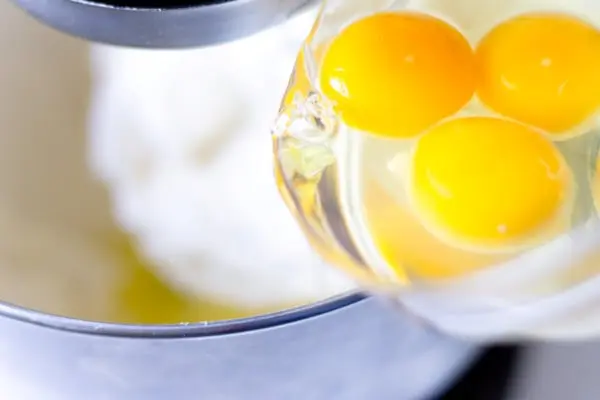 adding eggs to the batter