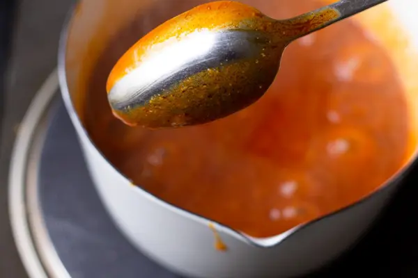 a spoon coat tested with buffalo sauce