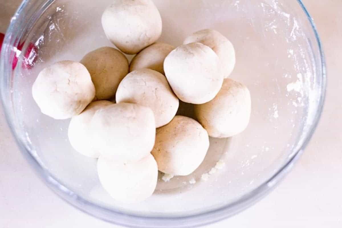 corn tortilla dough balls in a bowl resting