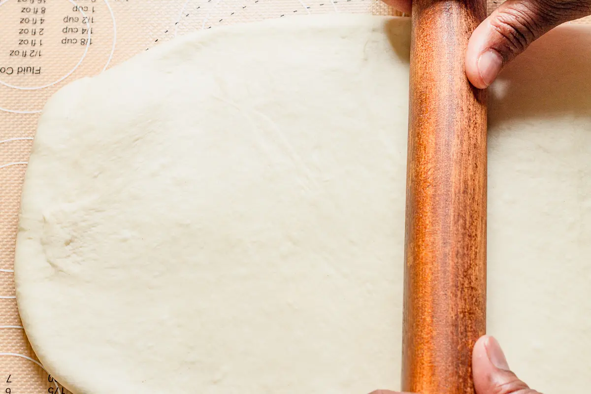 bread dough being rolled out