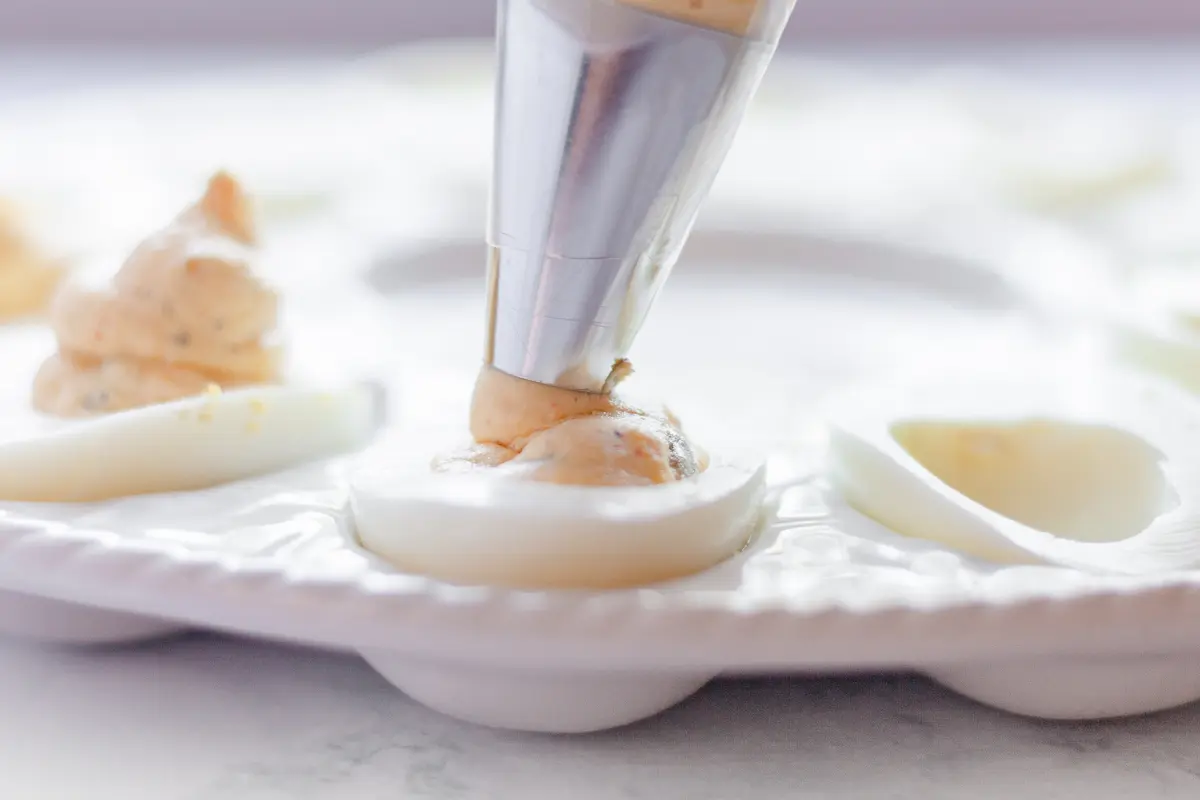 piping yolk cream into whites