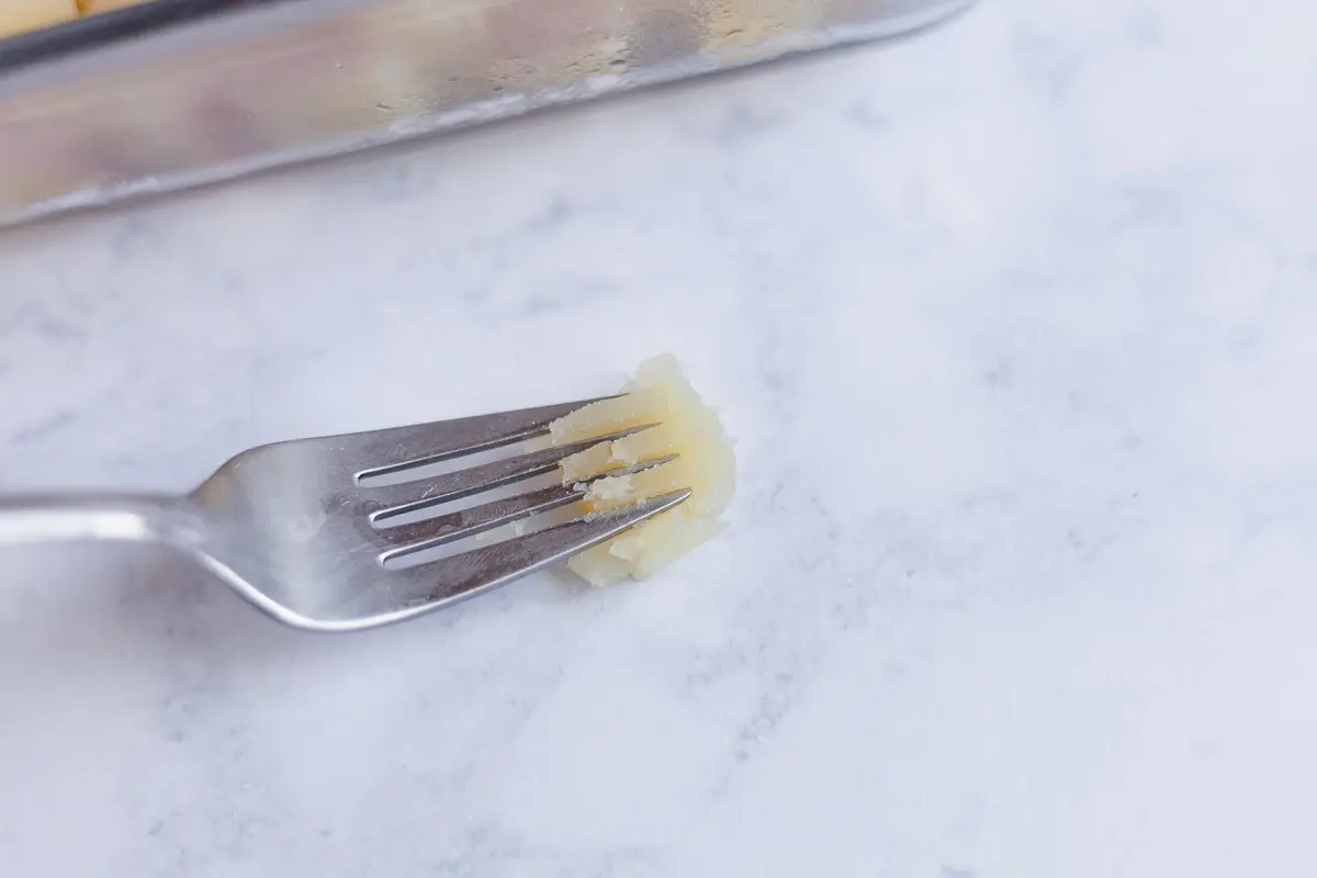 use a fork to measure firmness of a potatof