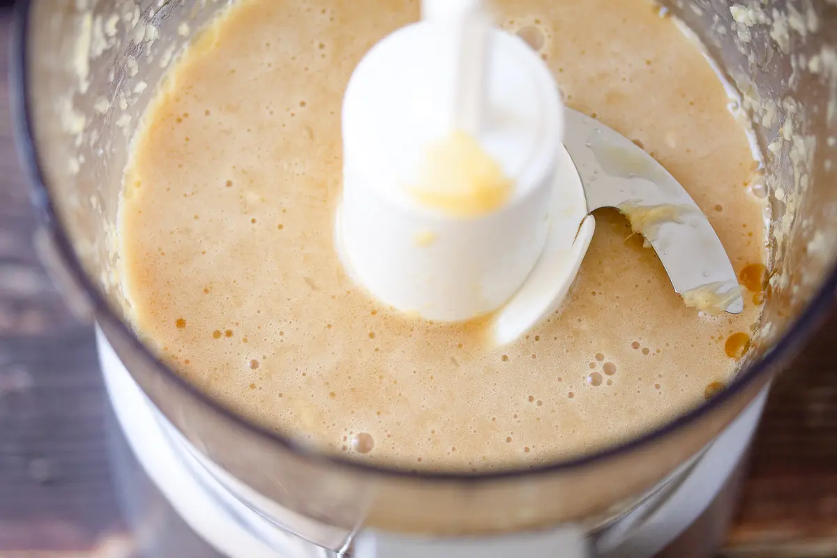 dressing ingredients in a food processor after processing