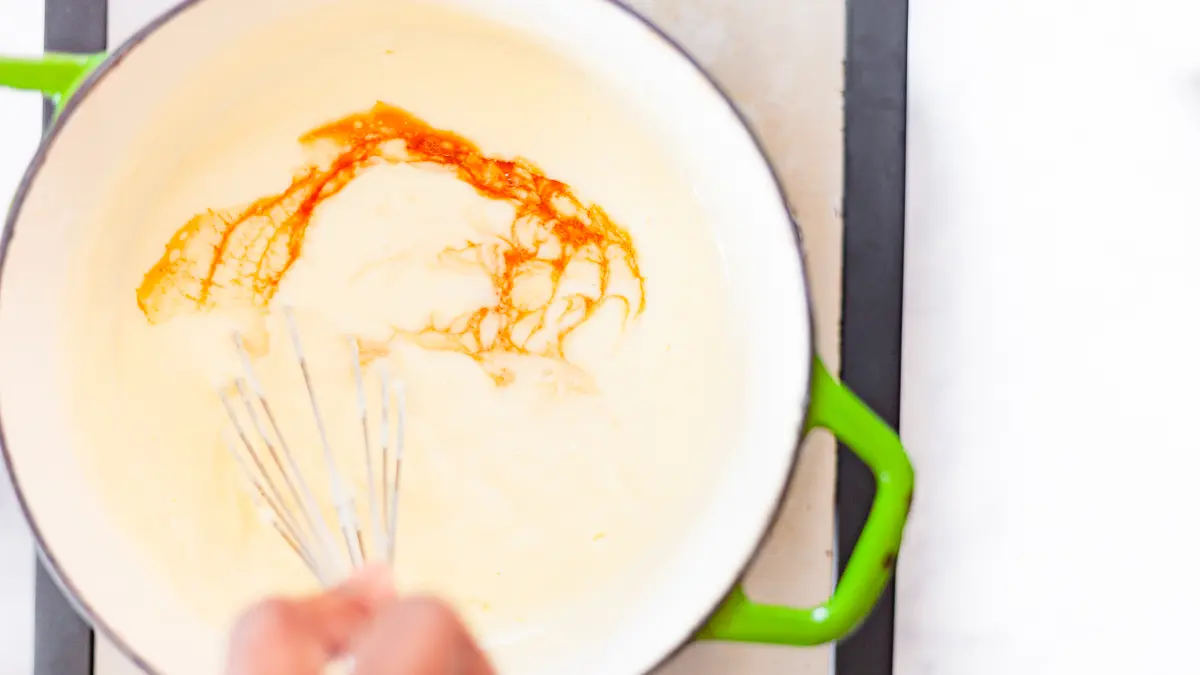 whisking vanilla into custard