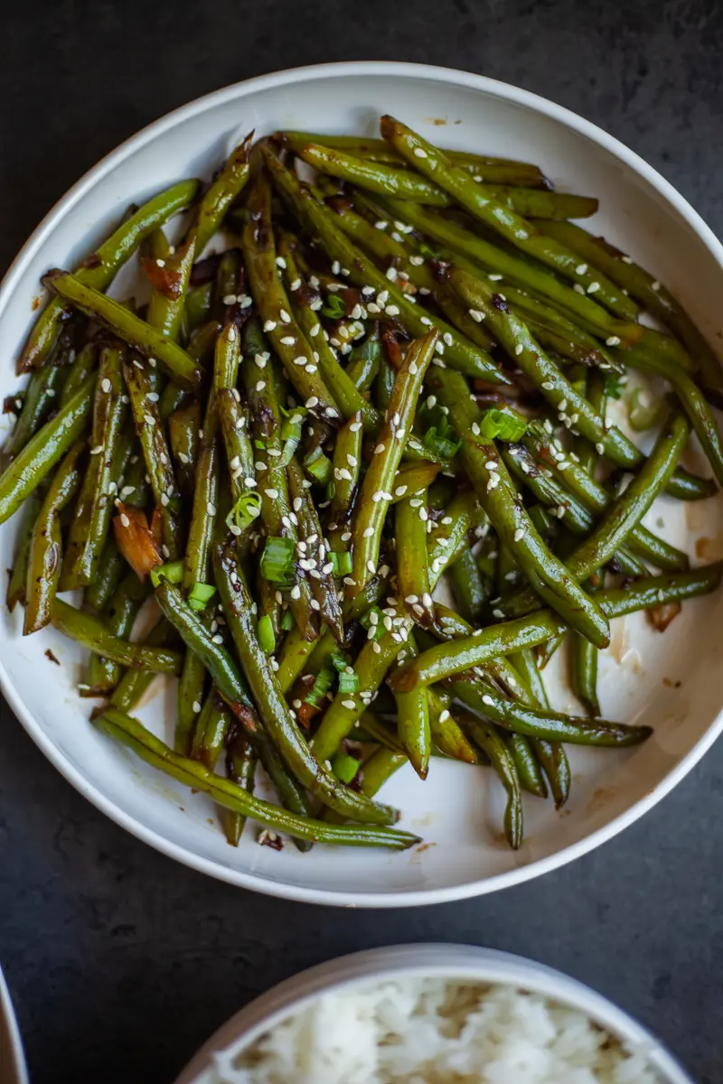 a plate of cooked garlic green beans