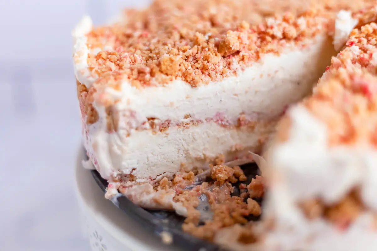 strawberry crunch ice cream cake with a slice removed