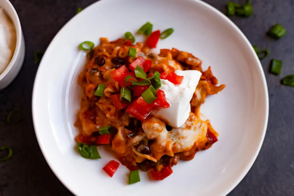 chicken lasagna on a white plate overhead
