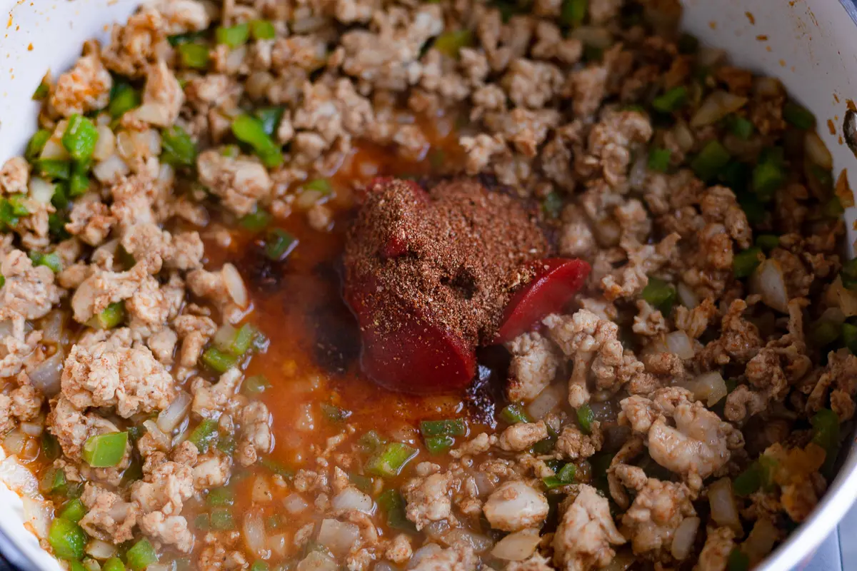 cooked chicken with tomato paste in a pan